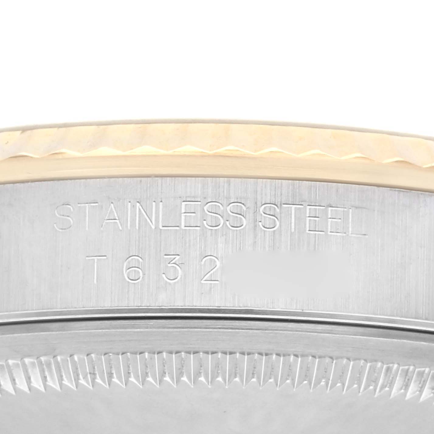 The image shows a close-up of the side of a Rolex Datejust 16233 Men's Steel and Gold (two tone) Champagne Dial 16233 Men's Steel and Gold (two tone) Champagne Dial's stainless steel case with engraving.