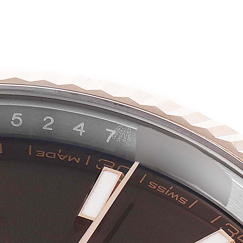 This close-up image shows the bezel, a portion of the chapter ring, and part of the dial of the Rolex Datejust 41 126331 Men's Steel and Gold (two tone) Brown Dial 126331 Men's Steel and Gold (two tone) Brown Dial watch.