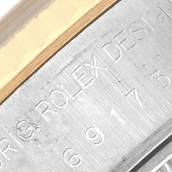 The image shows a close-up of the Rolex Datejust 69173 Women's Steel and Gold (two tone) Blue Dial 69173 Women's Steel and Gold (two tone) Blue Dial case edge with engraved branding and model details.