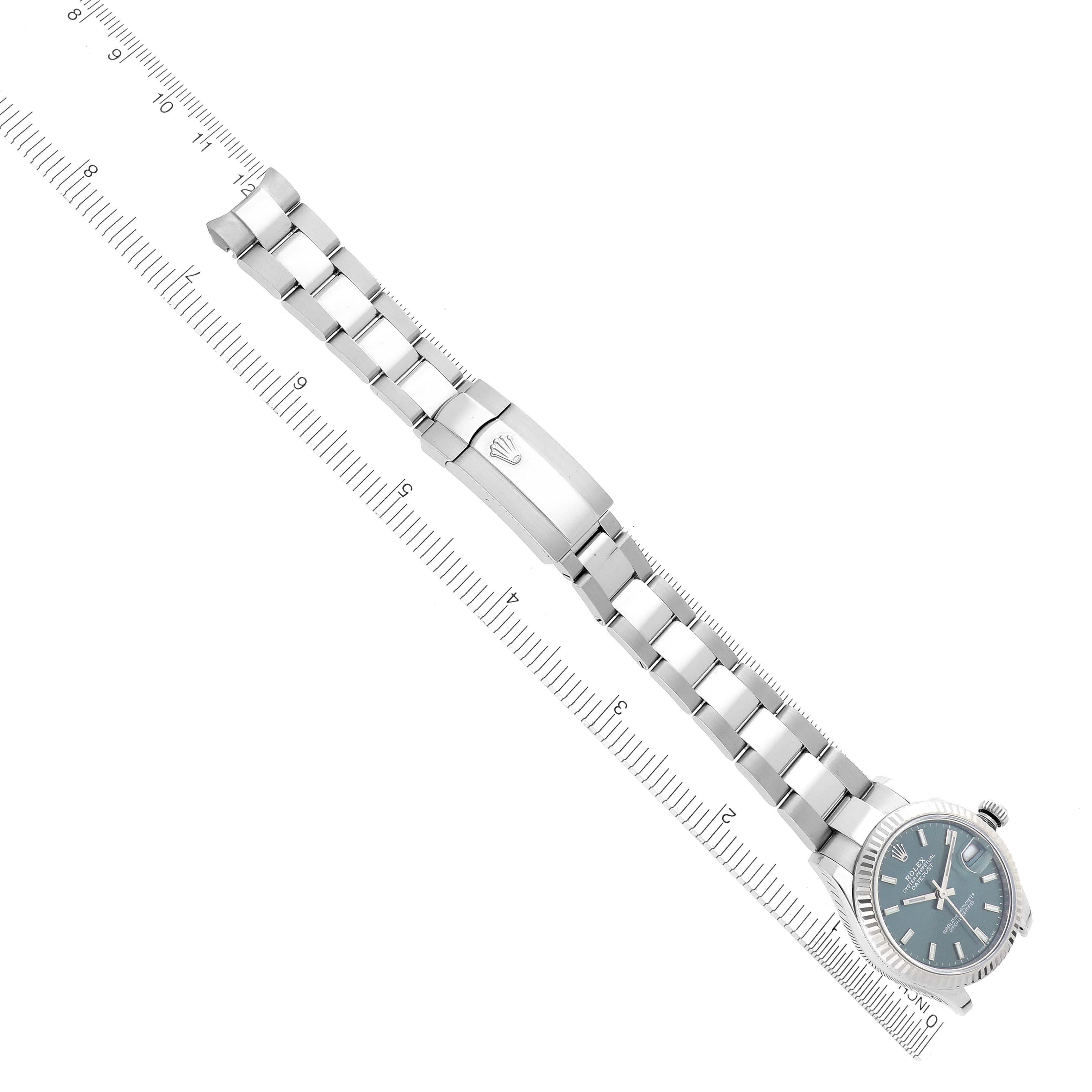 The Rolex Mid-Size 278274 Women's Stainless Steel Green Dial 278274 Women's Stainless Steel Green Dial watch is shown from a top view, featuring the bracelet and clasp, aligned with a ruler.