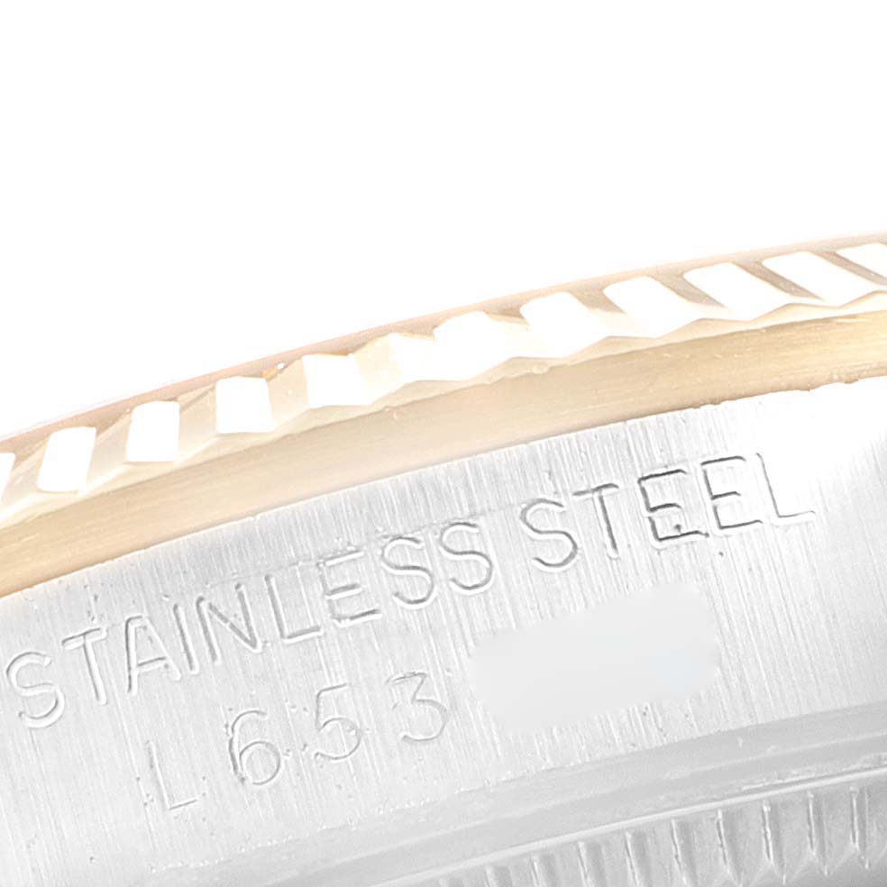 This image shows a close-up of the stainless steel bezel edge and engraved text on a Rolex Mid-Size 68273 Women
s Steel and Gold (two tone) Champagne Dial 68273 Women
s Steel and Gold (two tone) Champagne Dial watch.