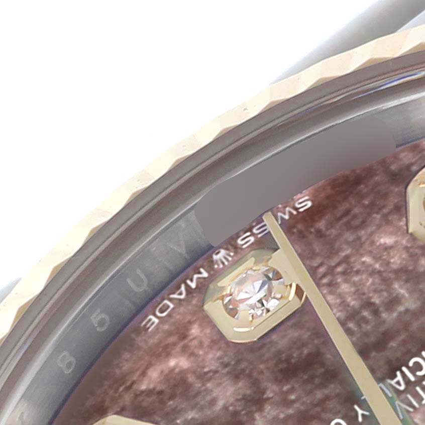 The image shows an angled close-up of a Rolex Mid-Size 278273 Women's Steel and Gold (two tone) Mother of Pearl Dial 278273 Women's Steel and Gold (two tone) Mother of Pearl Dial watch dial, featuring diamond markers and part of the fluted bezel.