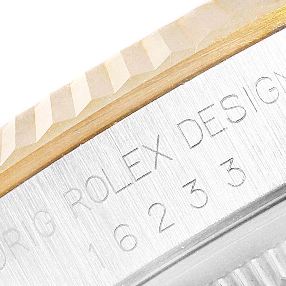 The image shows a close-up of the bezel and part of the case with the model number of a Rolex Datejust 16233 Men
s Steel and Gold (two tone) Champagne Dial 16233 Men
s Steel and Gold (two tone) Champagne Dial watch.