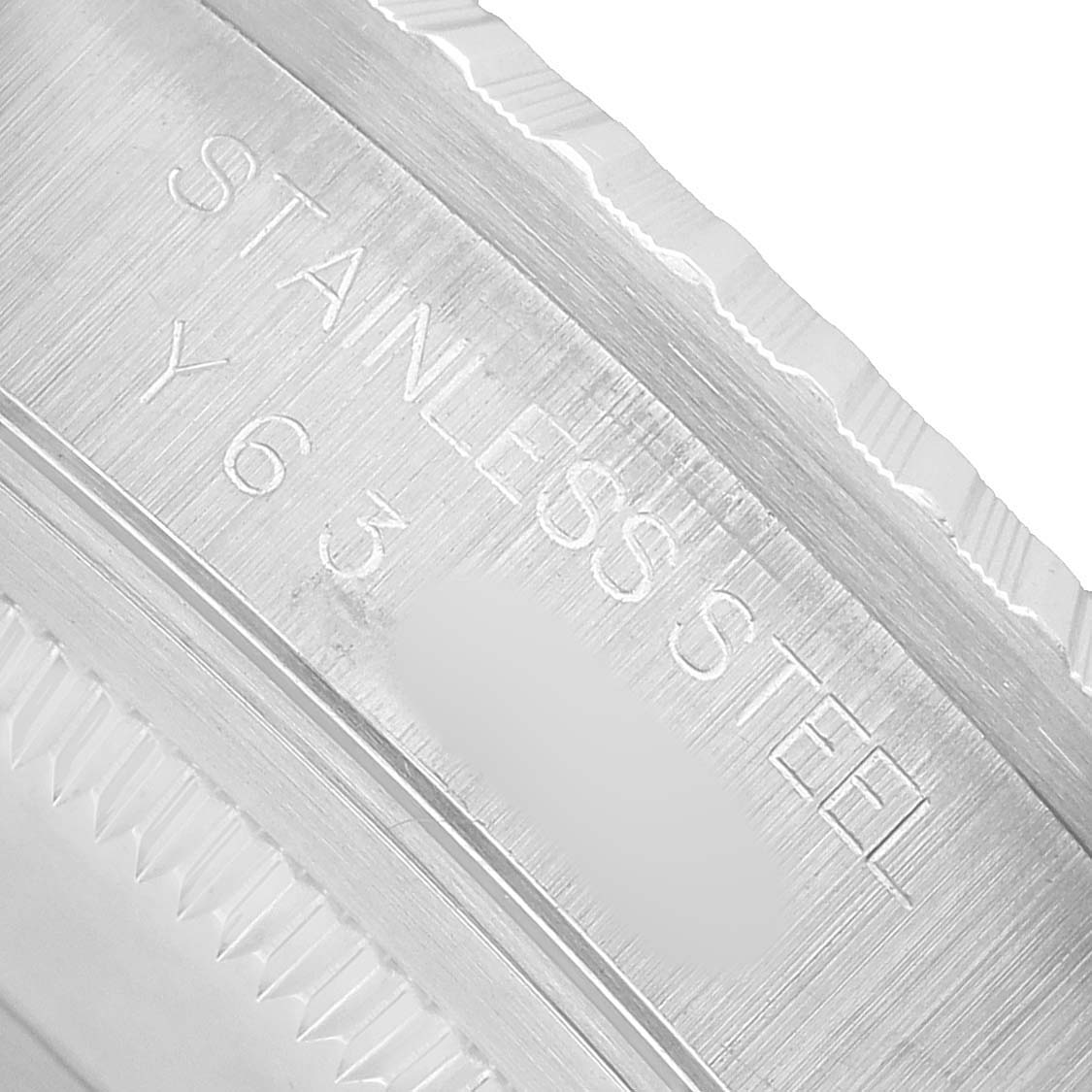 The image shows a close-up of the Rolex Datejust 16220 Men's Stainless Steel Silver Dial's rim, highlighting engravings and texture details.