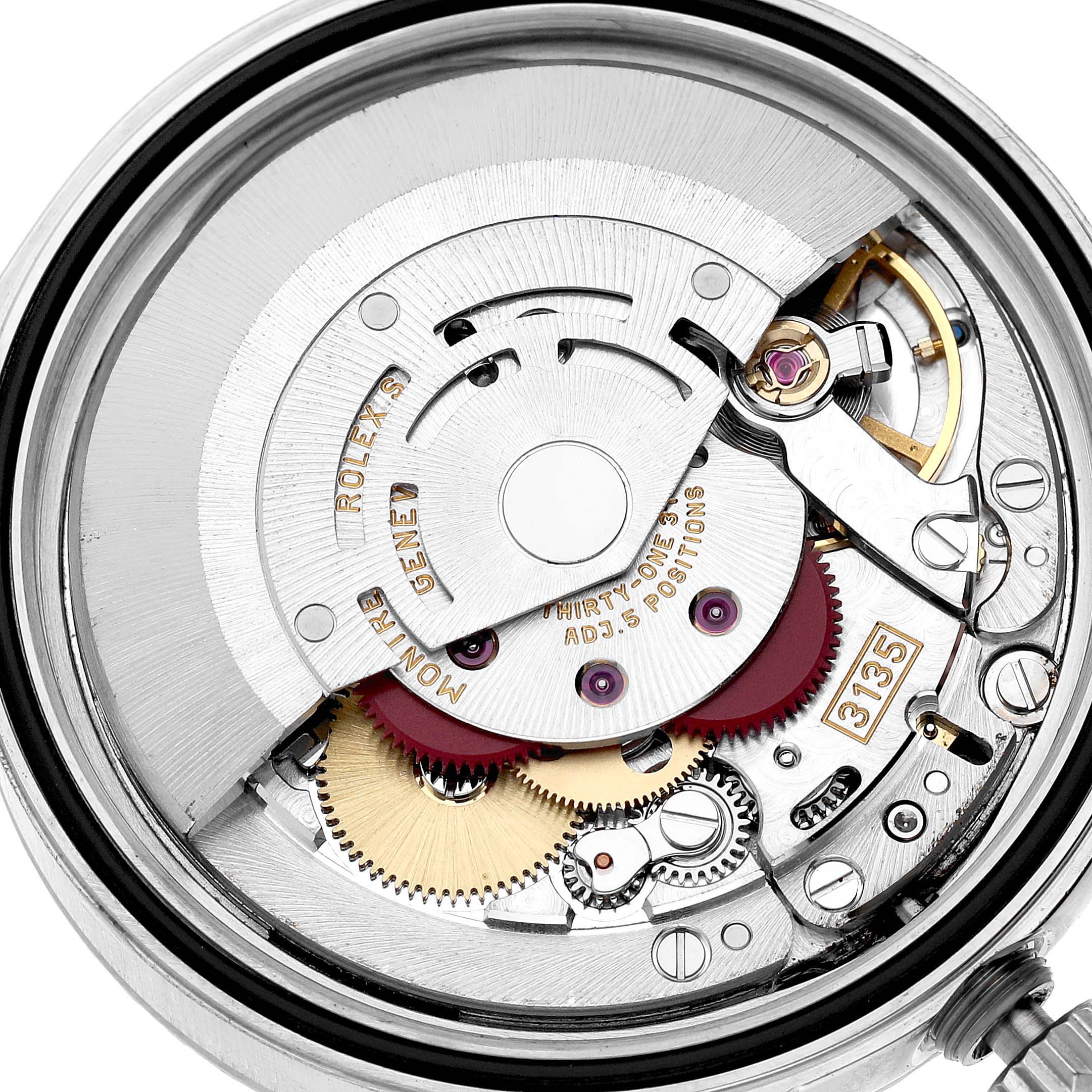 The image shows the movement of a Rolex Datejust 16220 Men's Stainless Steel Silver Dial watch, focusing on gears and intricate components.
