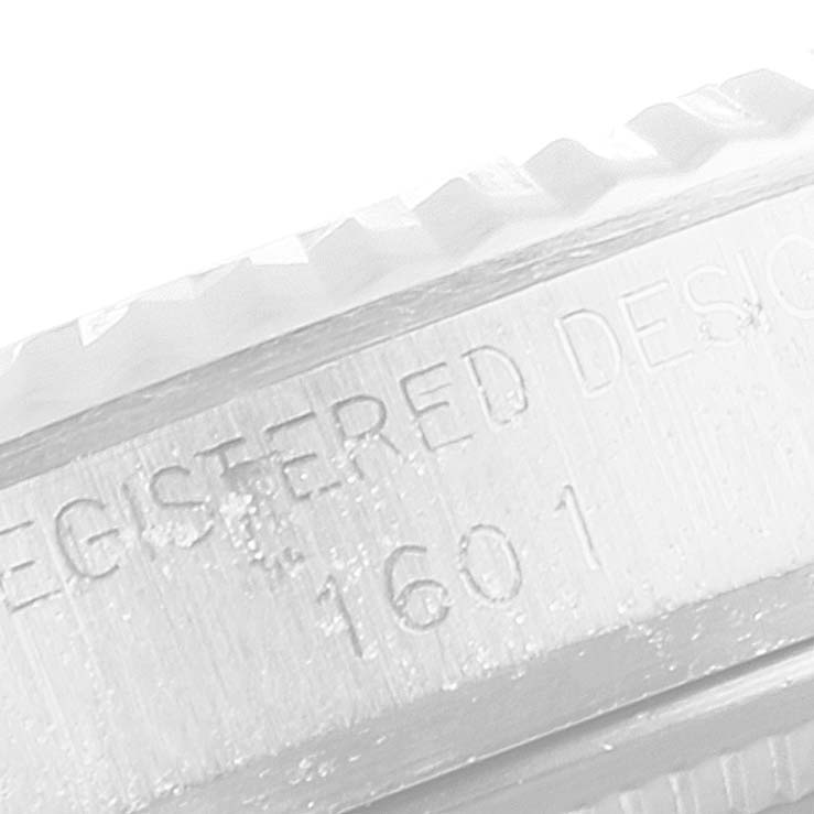 The image shows a close-up of the side bezel and engraved model number of a Rolex Vintage Collection 1601 Men
s Stainless Steel Silver Dial 1601 Men
s Stainless Steel Silver Dial watch.