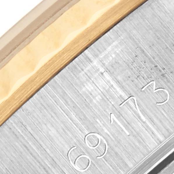 This image shows a close-up of the bezel and case number on a Rolex Datejust 69173 Women's Steel and Gold (two tone) Champagne Dial 69173 Women's Steel and Gold (two tone) Champagne Dial watch, highlighting its metal finish.
