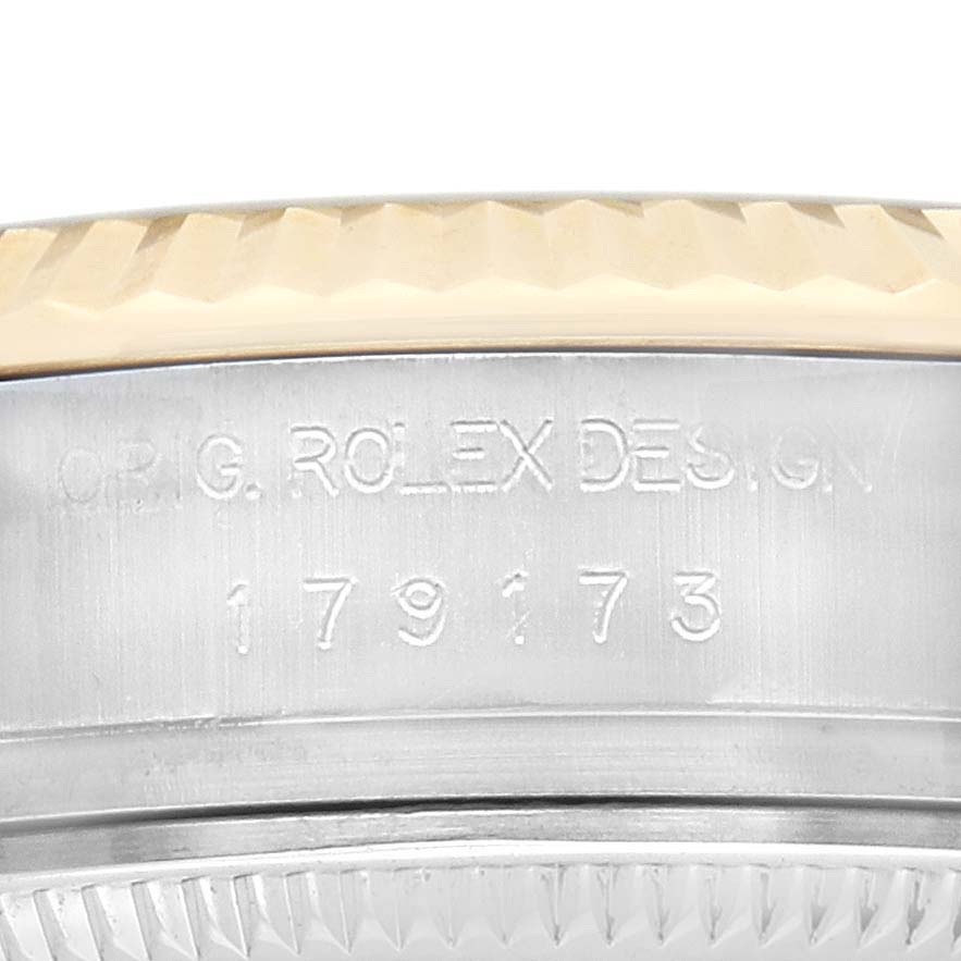 The image shows a close-up of a Rolex Datejust 179173 Women's Steel and Gold (two tone) Champagne Dial watch case side, highlighting the model number and "ORIG. ROLEX DESIGN" engraving.