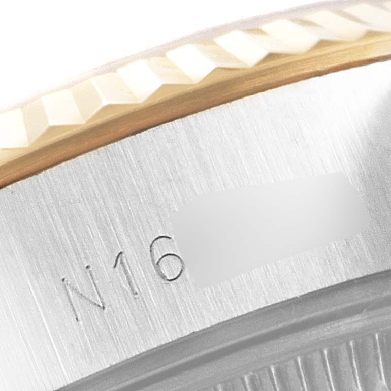 The image shows a close-up of the fluted bezel and engravings on the case rim of a Rolex Datejust 69173 Women
s Steel and Gold (two tone) Champagne Dial 69173 Women
s Steel and Gold (two tone) Champagne Dial watch.