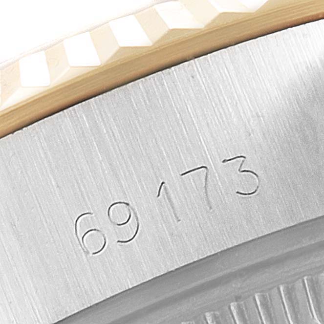 The image shows a close-up of the case side of a Rolex Datejust 69173 Women
s Steel and Gold (two tone) Champagne Dial 69173 Women
s Steel and Gold (two tone) Champagne Dial watch, focusing on its model number.