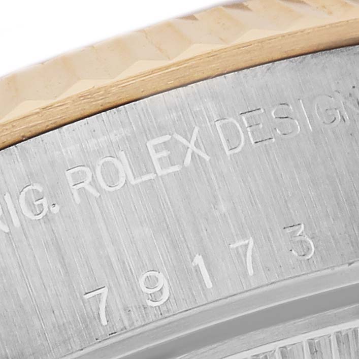 The image shows a close-up of the Datejust model by Rolex, focusing on the side engravings and bezel edge.