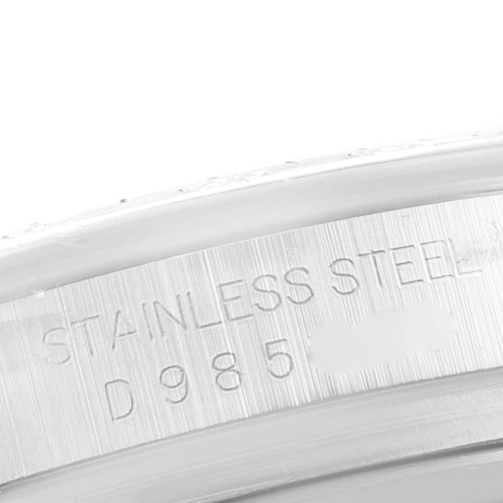 Close-up of the stainless steel rim with partial serial number of a Rolex Daytona 116520 Men's Stainless Steel Black Dial 116520 Men's Stainless Steel Black Dial watch.
