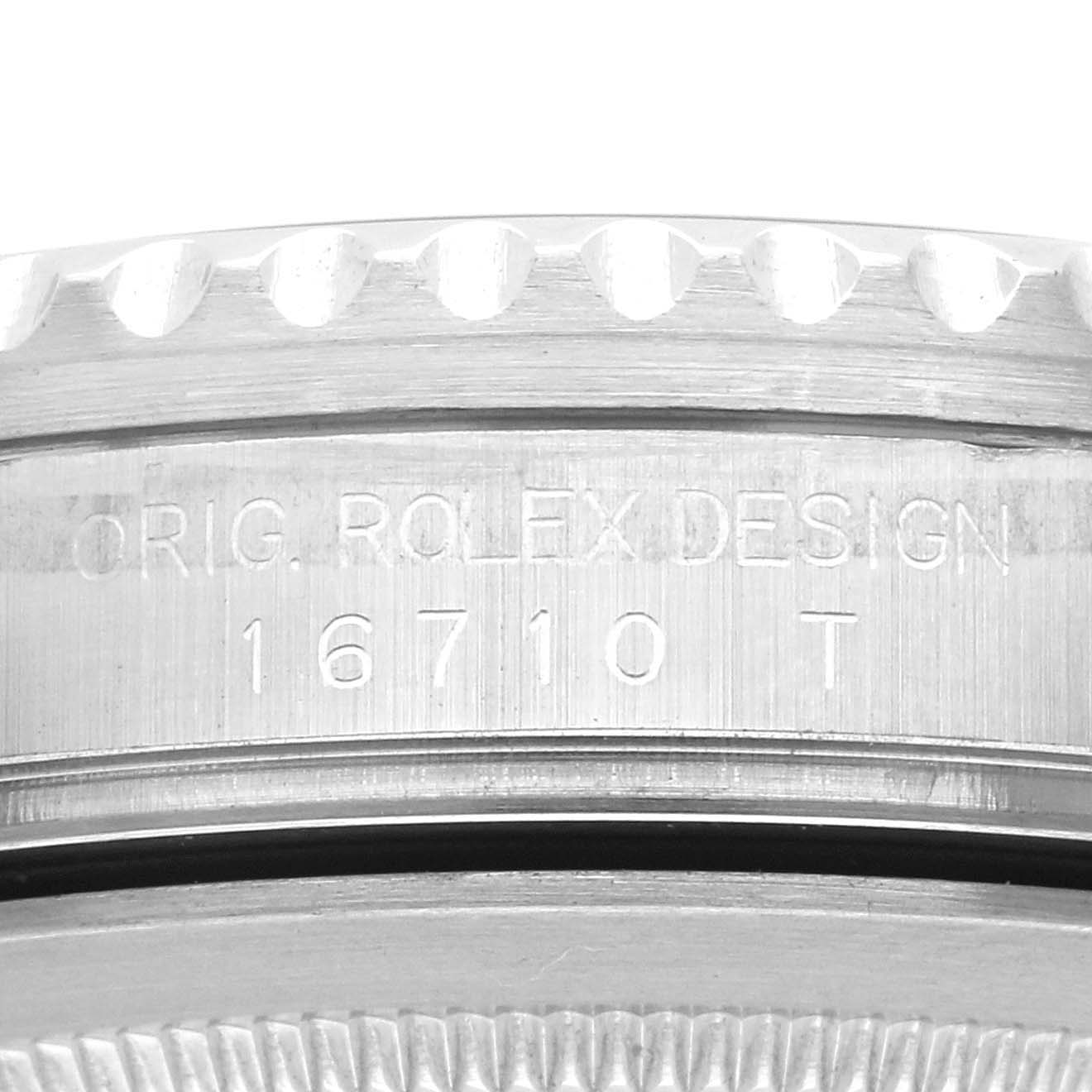 The image shows a close-up of the side engraving on a Rolex GMT-Master 16710 Men
s Stainless Steel Black Dial 16710 Men
s Stainless Steel Black Dial, displaying "ORIG. ROLEX DESIGN 16710 T".