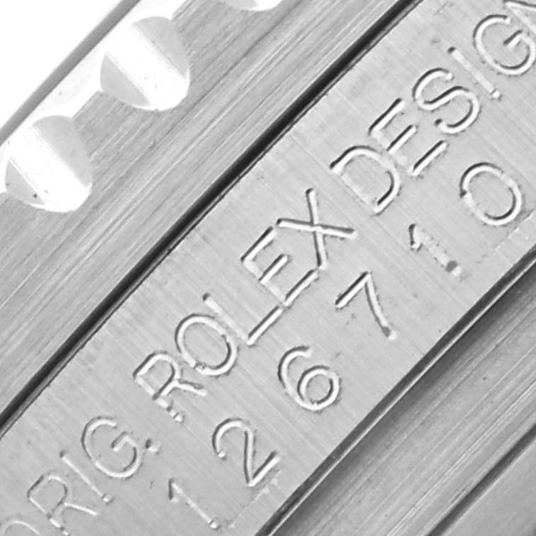 The image shows a close-up of the Rolex GMT-Master 126710BLRO Men's Stainless Steel Black Dial's bezel edge and engraved side, with "ROLEX DESIGN" visible.