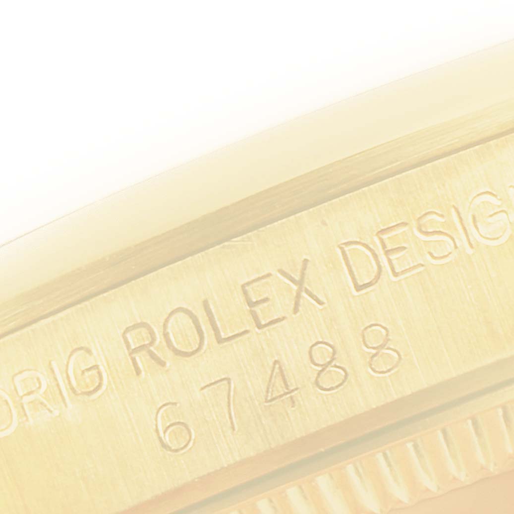 This is a close-up shot of the case edge showing the engraving on the Rolex President 67488 Women
s Yellow Gold White Dial 67488 Women
s Yellow Gold White Dial model watch.