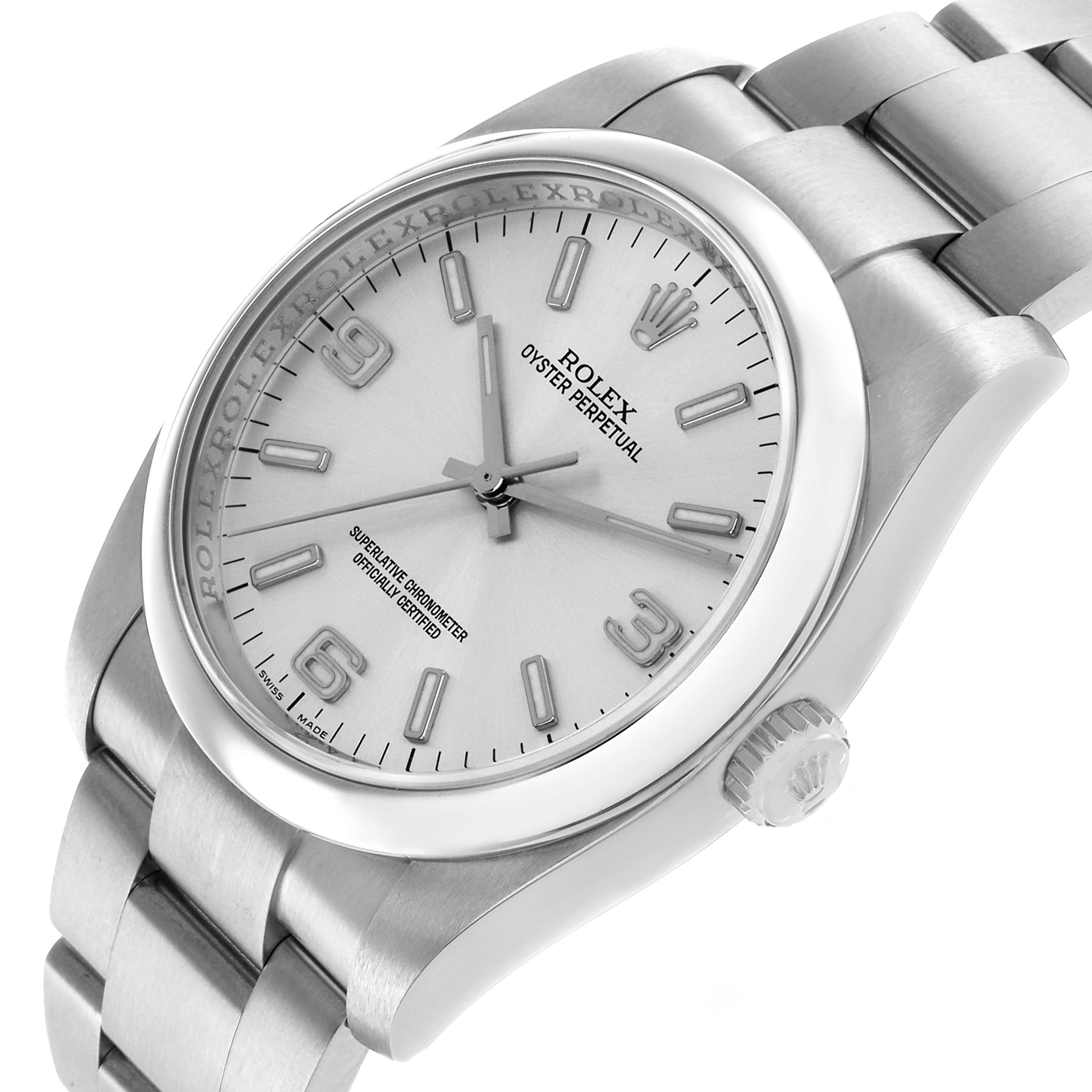 The Rolex Oyster Perpetual 116000 Men's Stainless Steel Silver Dial watch is shown at a slight angle, highlighting the dial, bezel, and part of the bracelet.