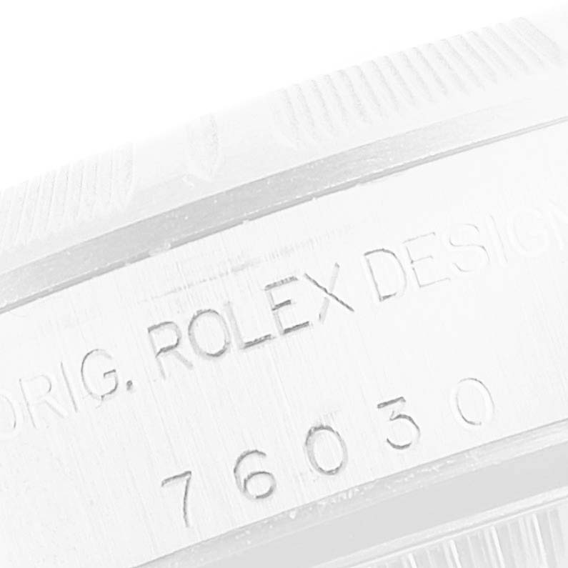 This image shows an angled close-up view of the side engraving on the case of a Rolex Oyster Perpetual 76030 Women's Stainless Steel Pink Dial 76030 Women's Stainless Steel Pink Dial watch.