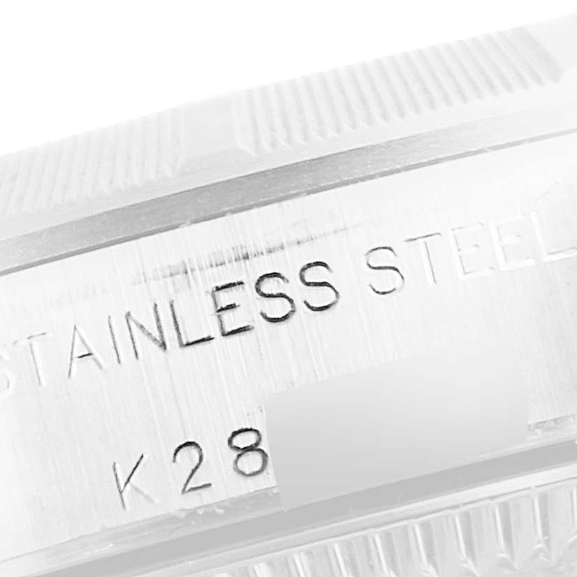 This is a macro shot of the side engraving on a stainless steel Rolex Oyster Perpetual 76030 Women's Stainless Steel Pink Dial 76030 Women's Stainless Steel Pink Dial watch case, highlighting the serial number.