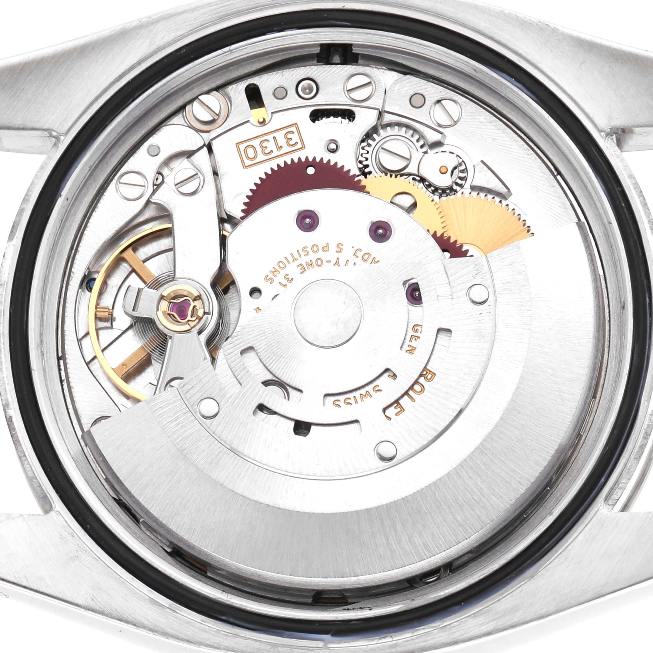 The image shows the back of a Rolex Oyster Perpetual 116034 Men's Stainless Steel Black Dial, revealing its internal movement and components.