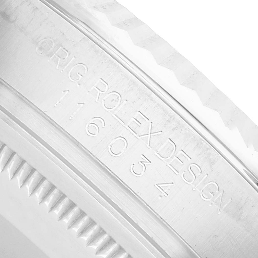 The image shows a close-up of the case side of a Rolex Oyster Perpetual 116034 Men's Stainless Steel Silver Dial, featuring engraved markings.