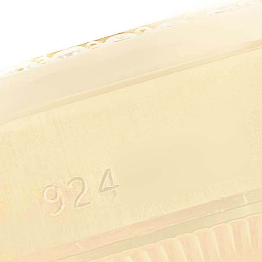 This close-up image shows the side of a Rolex President 69138 Women
s Yellow Gold Champagne Dial 69138 Women
s Yellow Gold Champagne Dial watch with a visible "924" engraving.