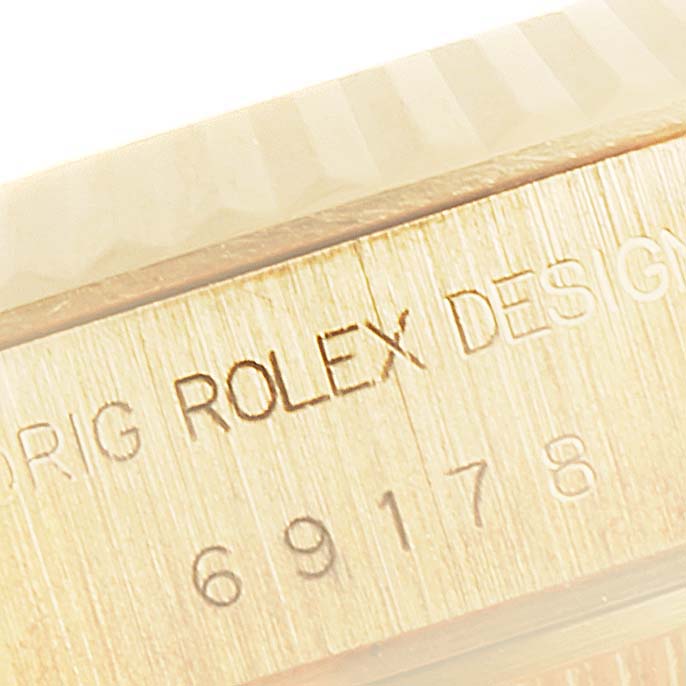 This close-up image shows the engraved design label and part of the case of the Rolex President 69178 Women
s Yellow Gold Champagne Dial 69178 Women
s Yellow Gold Champagne Dial model watch.