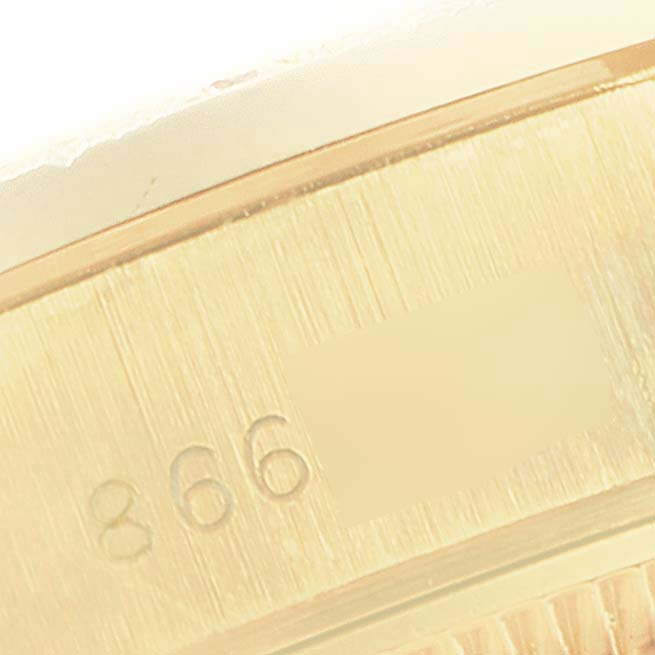 This image shows a close-up of the engraved serial number on the President model by Rolex.