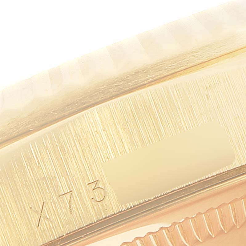 This close-up image shows the fluted bezel and part of the case with an engraving of the Rolex President 18238 Men
s Yellow Gold Champagne Dial 18238 Men
s Yellow Gold Champagne Dial model.