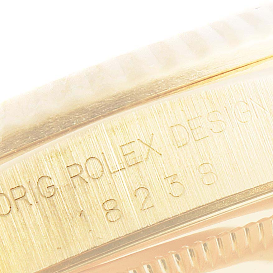 The image shows a close-up angle of the watch case side and bezel of the Rolex President 18238 Men
s Yellow Gold Champagne Dial 18238 Men
s Yellow Gold Champagne Dial model, featuring engraved text.