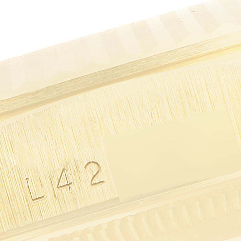 This image shows a close-up of the side of the case of a Rolex President 18238 Men's Yellow Gold Champagne Dial 18238 Men's Yellow Gold Champagne Dial watch, focusing on the serial number.