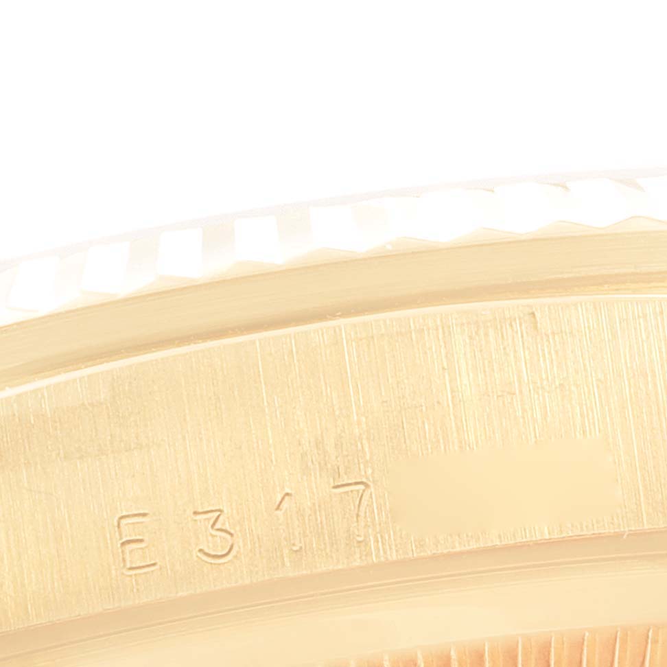 The image shows a close-up of the Rolex President 18238 Men's Yellow Gold Champagne Dial 18238 Men's Yellow Gold Champagne Dial watch, focusing on the textured bezel and engraved side.