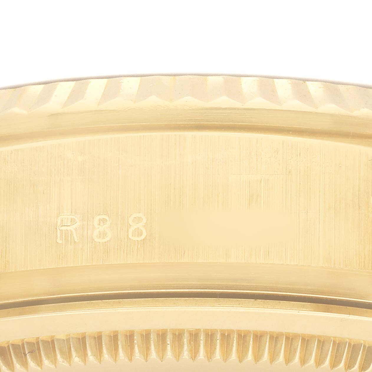 The image shows a close-up of the case back edge and part of the fluted bezel on a Rolex President 18038 Men's Yellow Gold Champagne Dial watch.