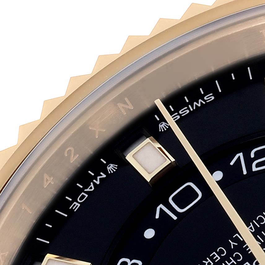 The image shows a close-up of the Rolex Sky-Dweller 336238 Men's Yellow Gold Black Dial 336238 Men's Yellow Gold Black Dial's bezel, dial edge, and indices from an angled view.