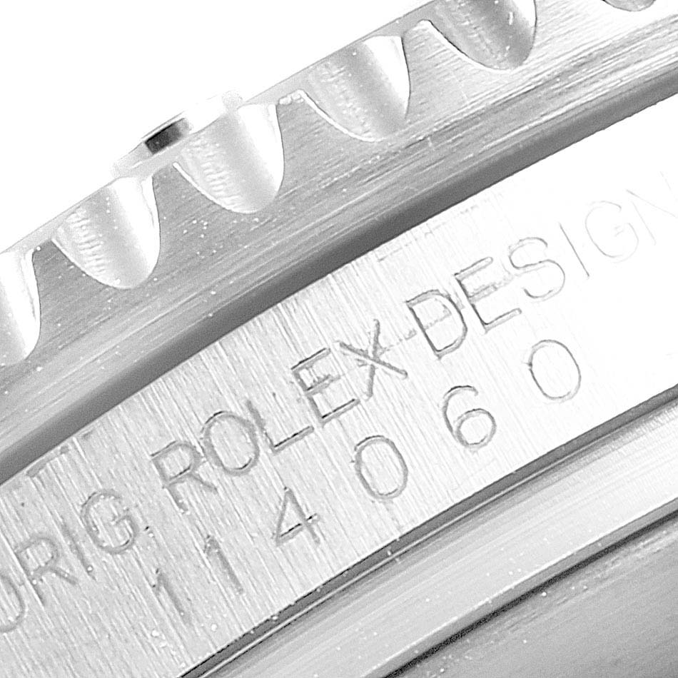 Close-up of the side of the Rolex Submariner 114060 Men
s Stainless Steel Black Dial 114060 Men
s Stainless Steel Black Dial, showing the serial number and part of the bezel.