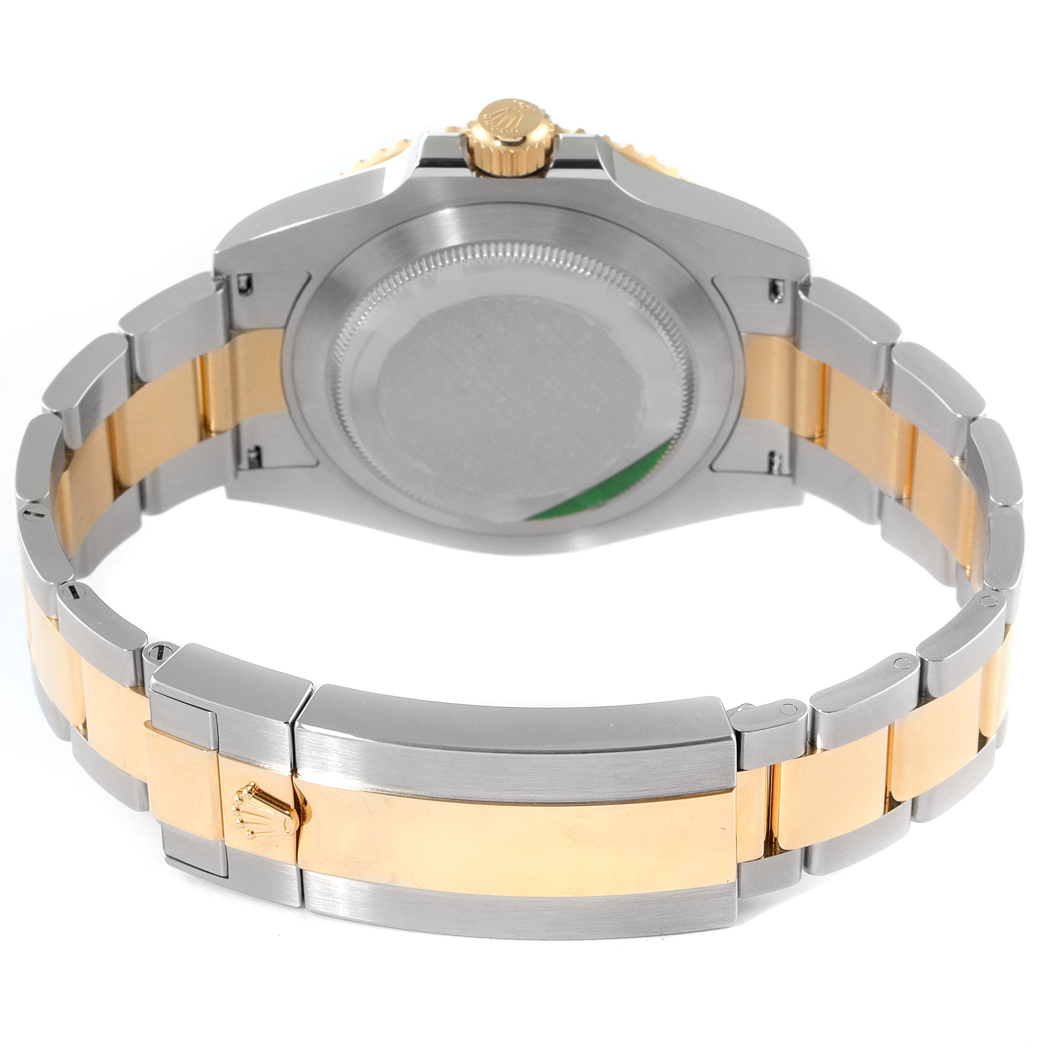 The image shows the backside and bracelet of a Rolex Submariner 126613 Men's Steel and Gold (two tone) Black Dial 126613 Men's Steel and Gold (two tone) Black Dial, highlighting the gold and silver elements and the fold-over clasp.