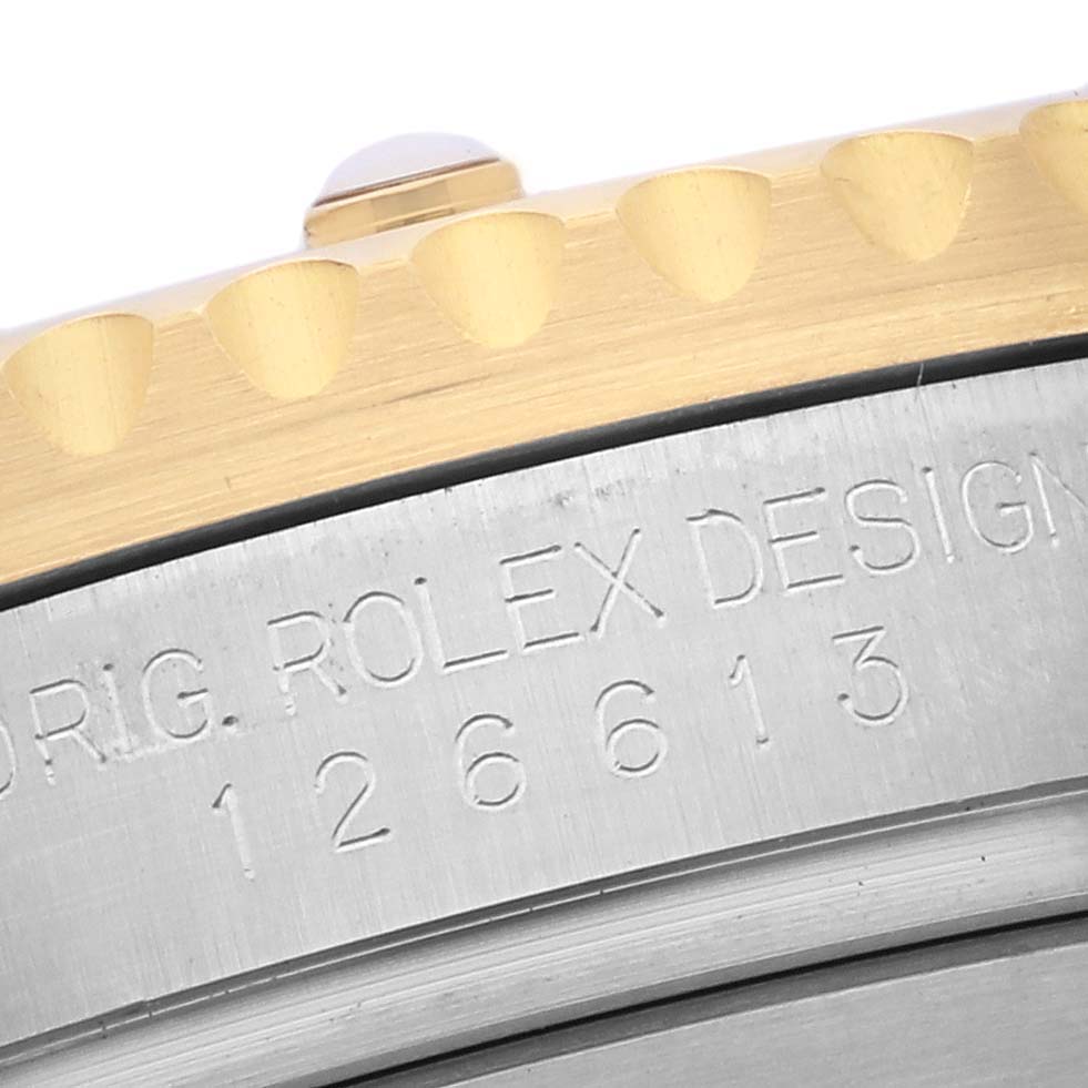 The image shows a close-up of the engraved case side and bezel edge of a Rolex Submariner 126613LB Men's Steel and Gold (two tone) Blue Dial 126613LB Men's Steel and Gold (two tone) Blue Dial.