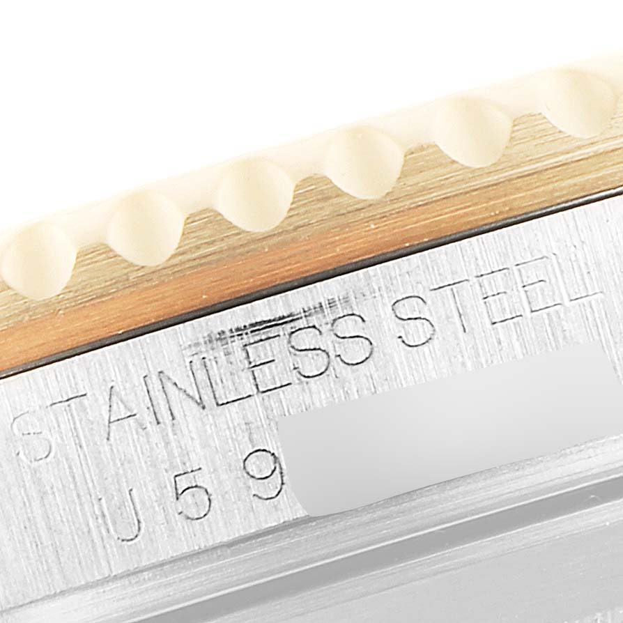 The image shows a close-up of the Rolex Submariner 16613 Men's Steel and Gold (two tone) Blue Dial 16613 Men's Steel and Gold (two tone) Blue Dial model's stainless steel case and part of the bezel.