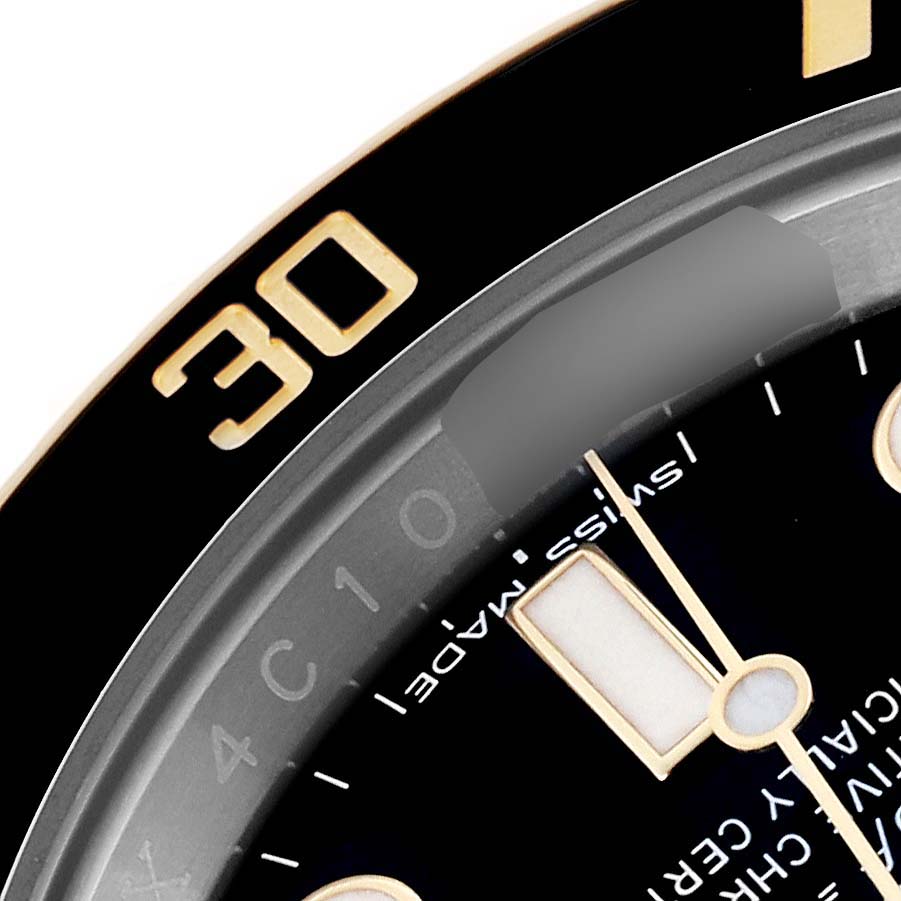 The image shows a close-up of the bezel and part of the dial of a Rolex Submariner 116613LN Men's Steel and Gold (two tone) Black Dial 116613LN Men's Steel and Gold (two tone) Black Dial watch.