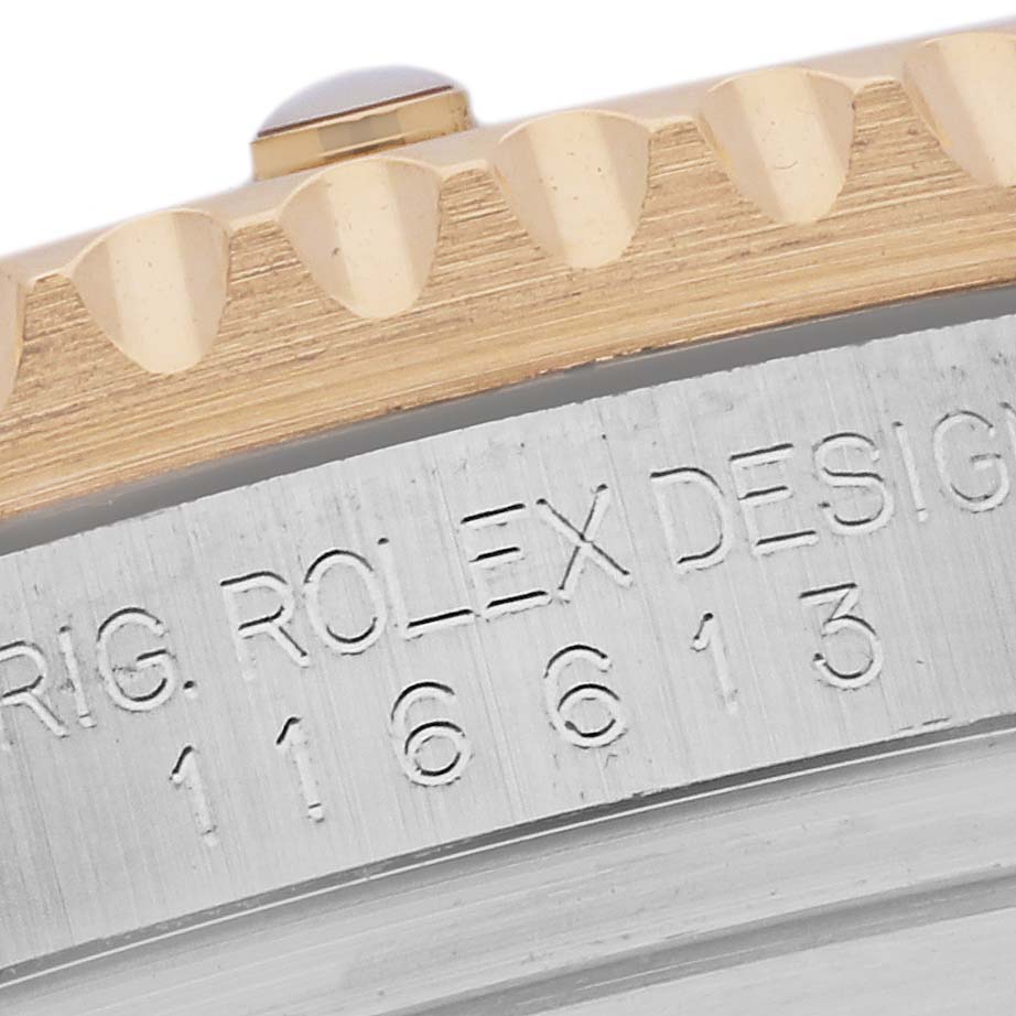 The image shows the edge of a Rolex Submariner 116613LN Men's Steel and Gold (two tone) Black Dial 116613LN Men's Steel and Gold (two tone) Black Dial, highlighting the bezel and engraved side.