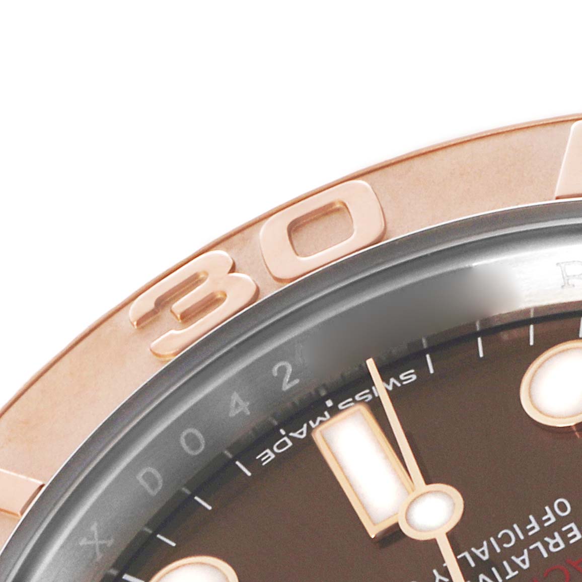 The image shows a close-up of the Rolex Yacht-Master 116621 Men's Steel and Gold (two tone) Brown Dial's bezel and part of the dial with hour markers.