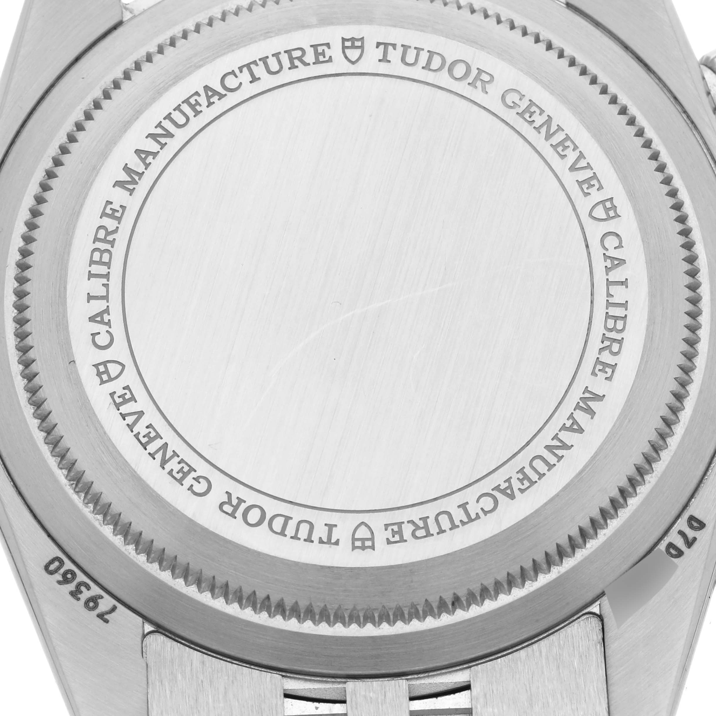 The image shows the back case of a Tudor Heritage Black Bay M79360N-0019 Men's Stainless Steel Pink Dial M79360N-0019 Men's Stainless Steel Pink Dial watch, highlighting engravings and a portion of the bracelet attachment.