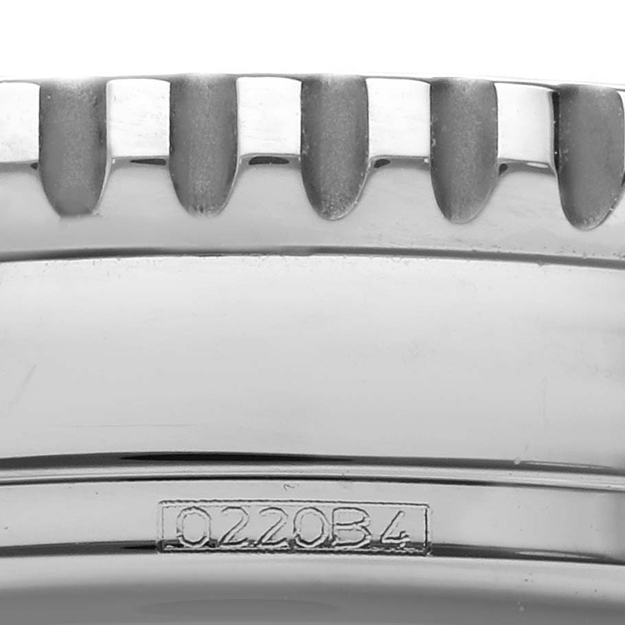 The image shows a close-up of the side view of the Breitling Navitimer A13324 Men
s Stainless Steel Blue Dial A13324 Men
s Stainless Steel Blue Dial
s bezel and part of the case with engravings.