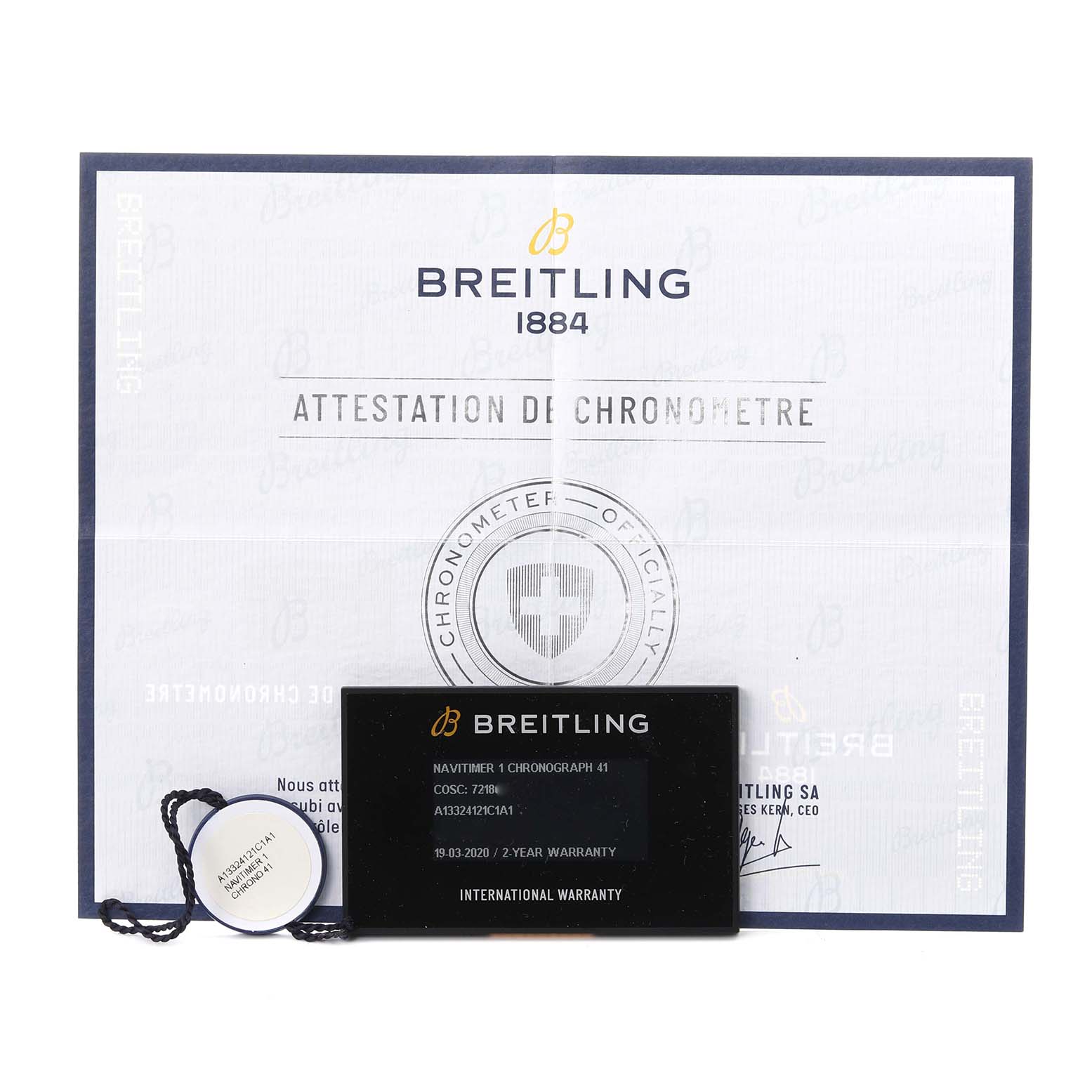 The image shows the Breitling Navitimer A13324 Men
s Stainless Steel Blue Dial A13324 Men
s Stainless Steel Blue Dial
s warranty card, tag, and chronometer certificate.