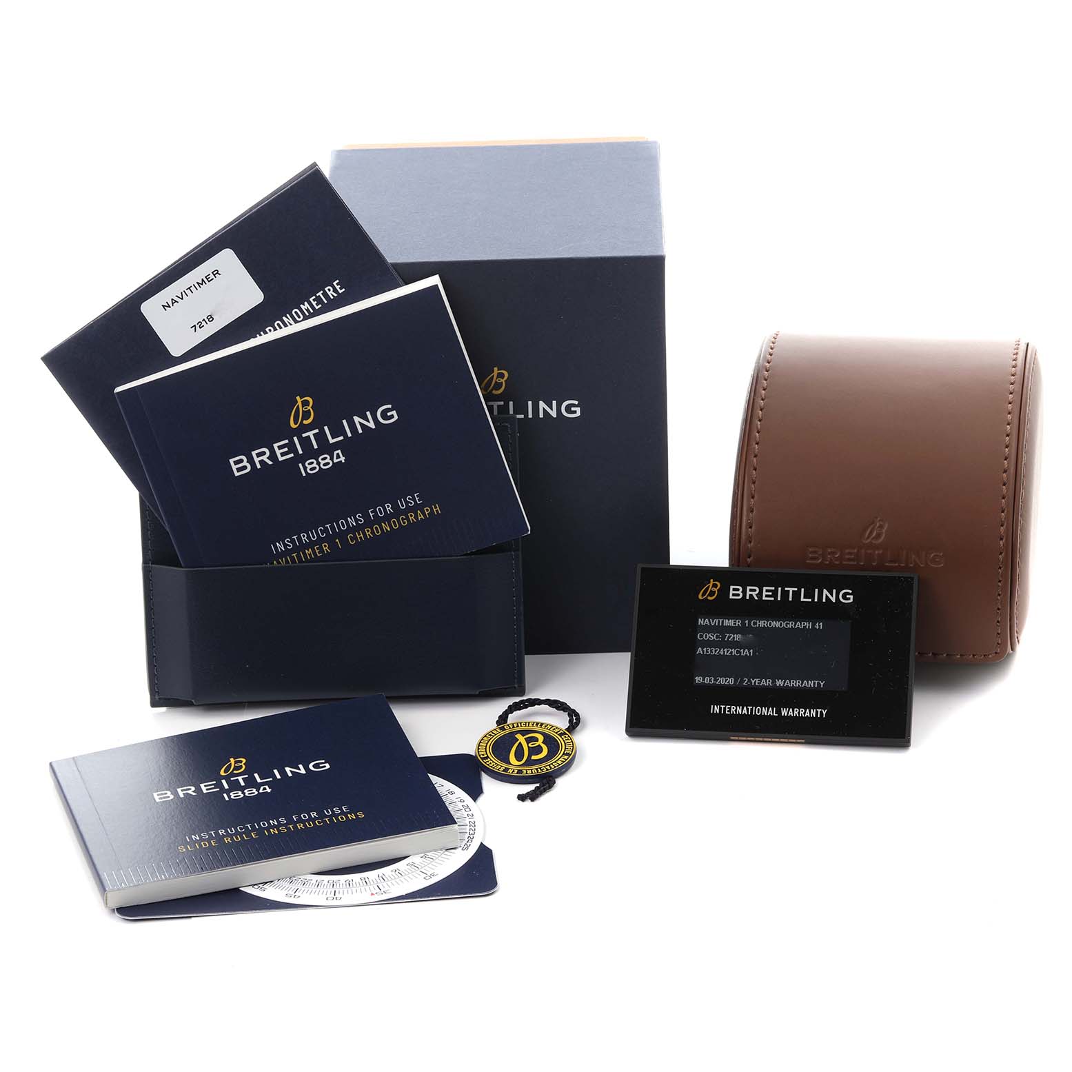 The image shows the Breitling Navitimer A13324 Men
s Stainless Steel Blue Dial A13324 Men
s Stainless Steel Blue Dial watch accessories including manuals, warranty card, strap, and a leather case.