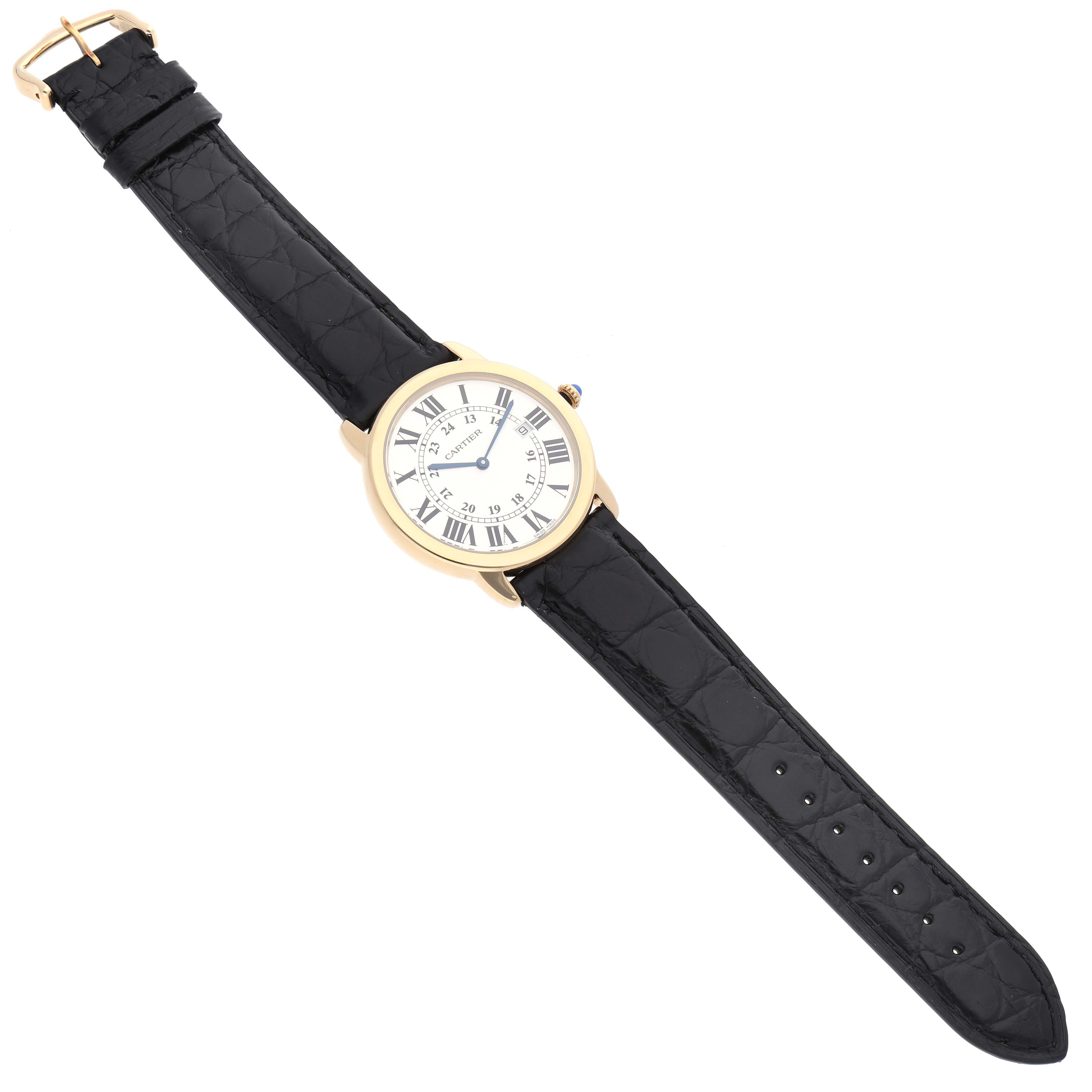 The Cartier Ronde W6700455 Men's Yellow Gold Silver Dial W6700455 Men's Yellow Gold Silver Dial watch is displayed from a top-down angle, showing the black leather strap and round face with Roman numerals.