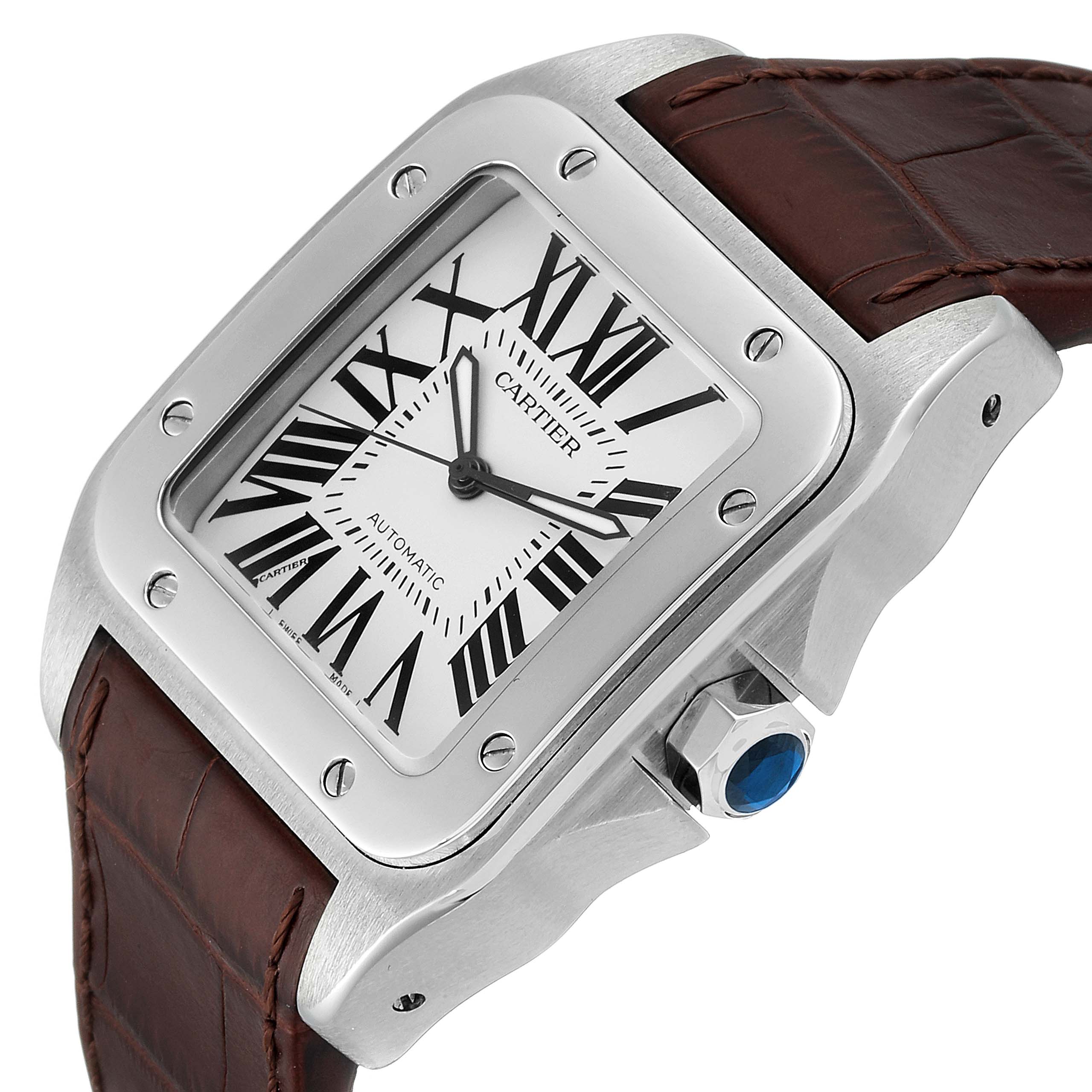 The image shows a Cartier Santos W20073X8 Men's Stainless Steel Silver Dial W20073X8 Men's Stainless Steel Silver Dial watch at an angle, highlighting its dial, bezel, crown with a blue gemstone, and leather strap.