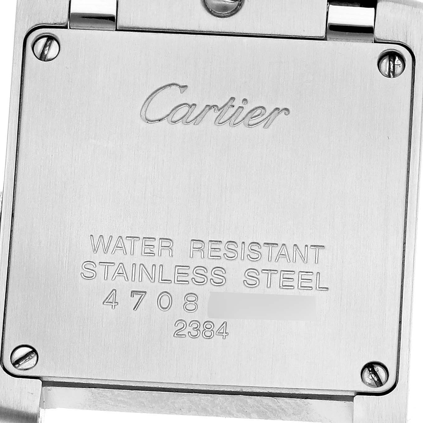 The image shows the back of a Cartier Tank Française watch, highlighting the stainless steel case and engraved text.