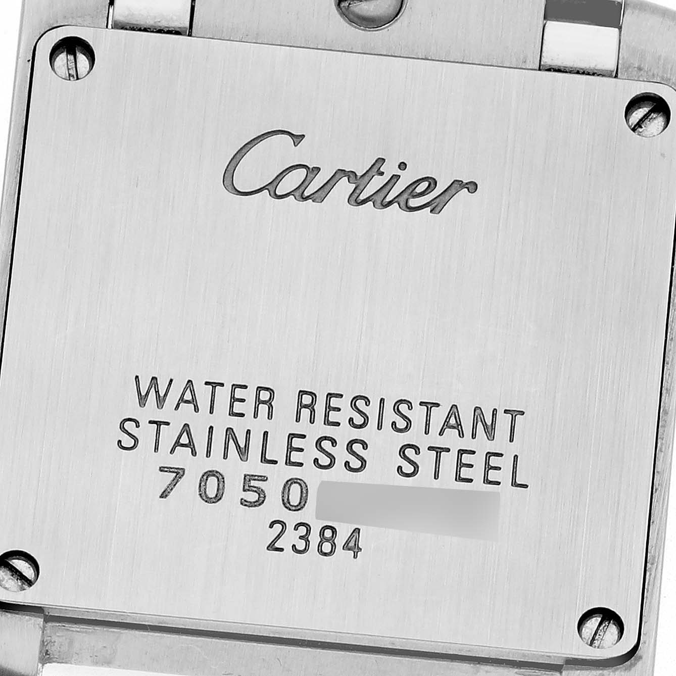 The image shows the stainless steel backplate of the Cartier Tank Française, highlighting branding and specifications.