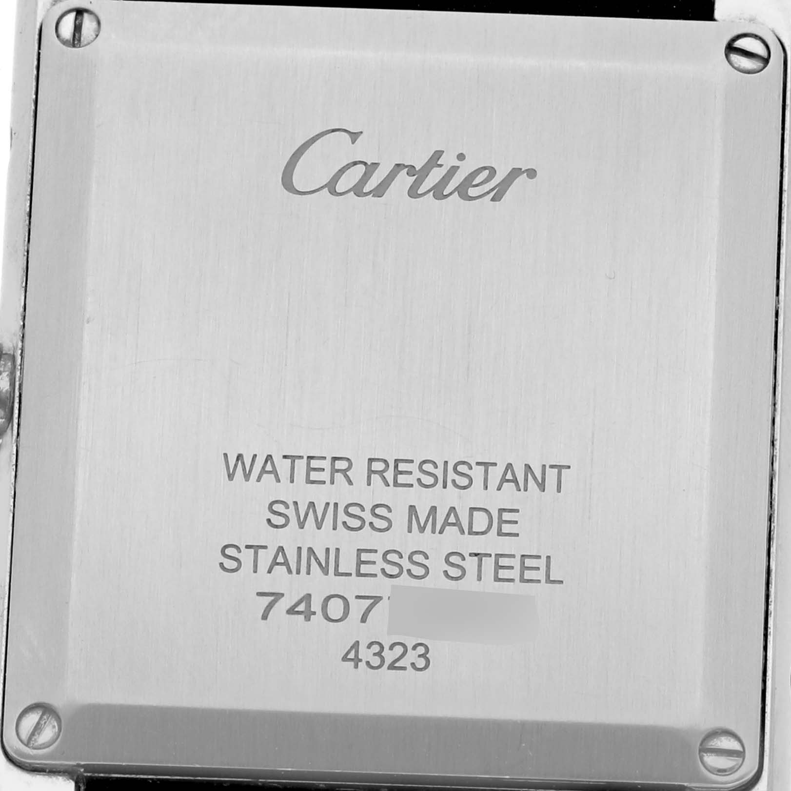 The image shows the back of a Cartier Tank Must W4TA0017 Women
s Stainless Steel Silver Dial W4TA0017 Women
s Stainless Steel Silver Dial watch, displaying brand and material information.