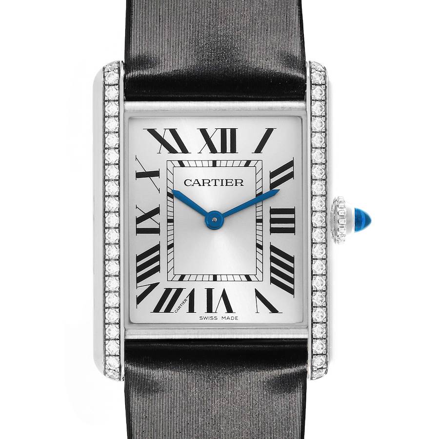 The Cartier Tank Must watch is shown from a front angle, highlighting the face, Roman numerals, and diamond-encrusted bezel.